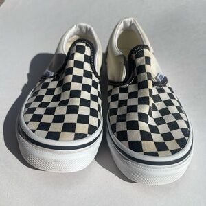 Black and white checkered slip-on Vans